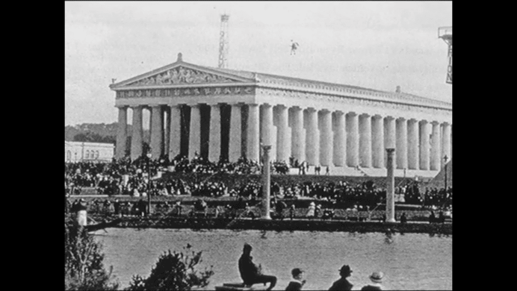 Historic black and white photograph of Nashville's Parthenon during the early 1900s, showing the complete exterior structure with its iconic Greek columns and triangular pediment, surrounded by crowds gathered for an event in Centennial Park