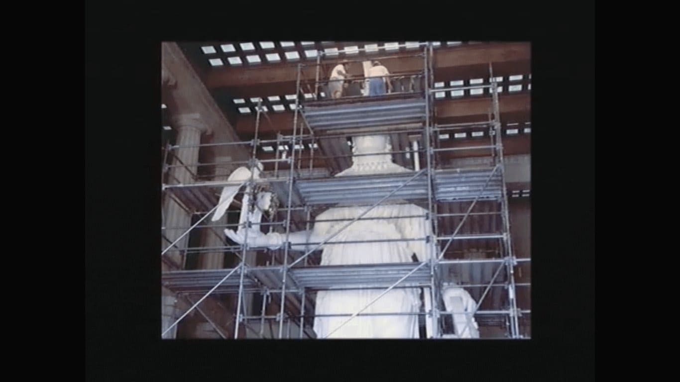 Workers on scaffolding restoring the Athena Parthenos statue inside Nashville Parthenon replica in Centennial Park Tennessee