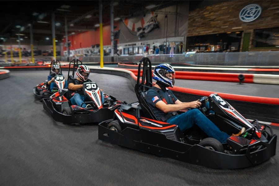 Zoom around tight turns at Nashville's indoor go-kart track, neon lights blazing