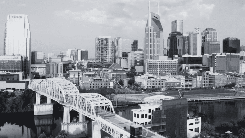 skyline view of Nashville showing historic architecture, iconic bridge spanning Cumberland River representing Tennessee's cultural heritage