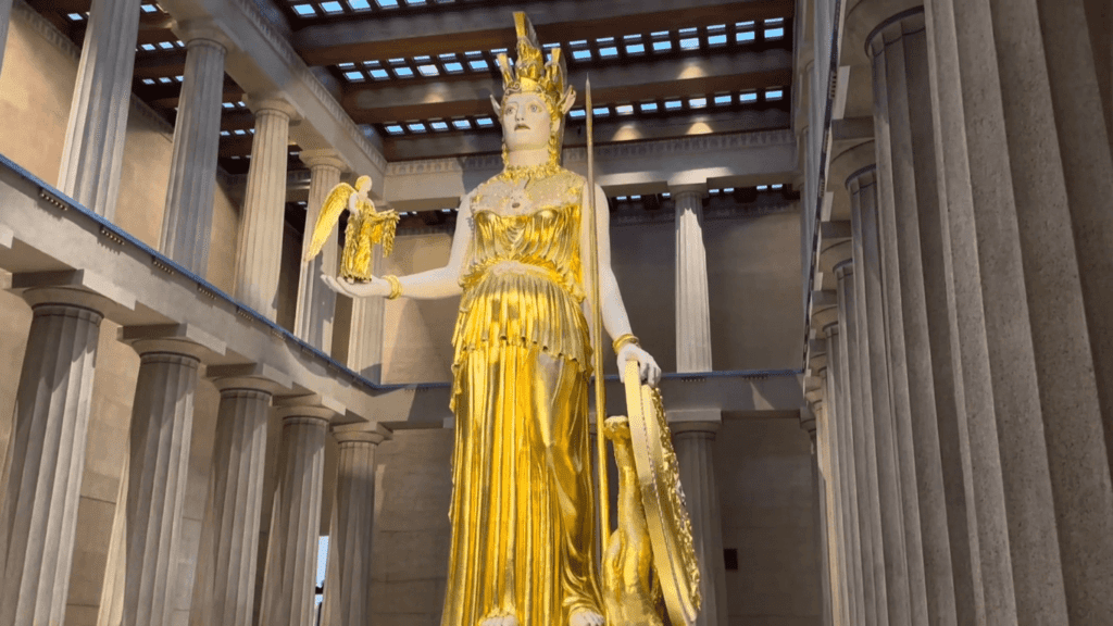 Gilded statue of Athena Parthenos inside the Nashville Parthenon, standing 42 feet tall with a shield, spear, and Nike figurine in her right hand