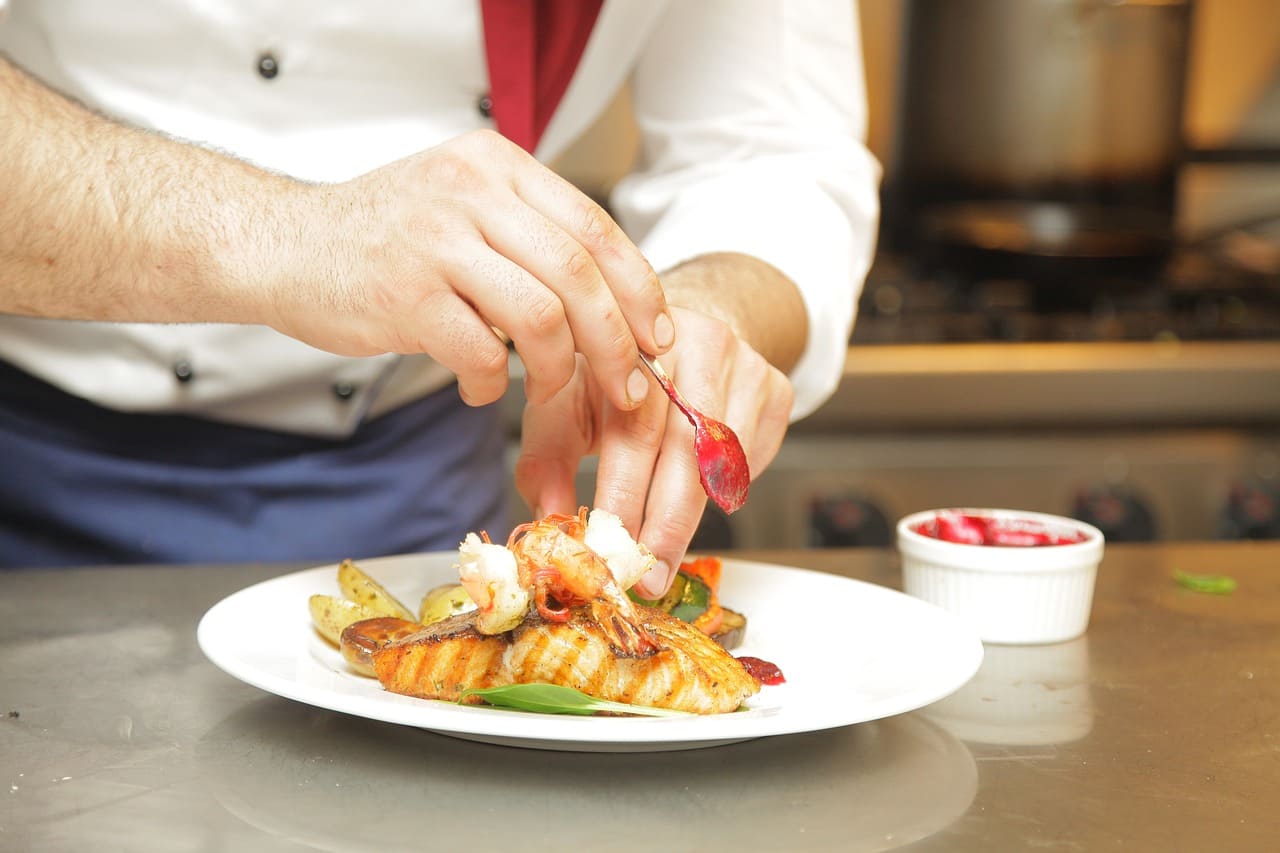 Immigrant chef crafts gourmet seafood dish on immigrant-owned restaurant showcasing Nashville’s hidden culinary gems beyond tradition