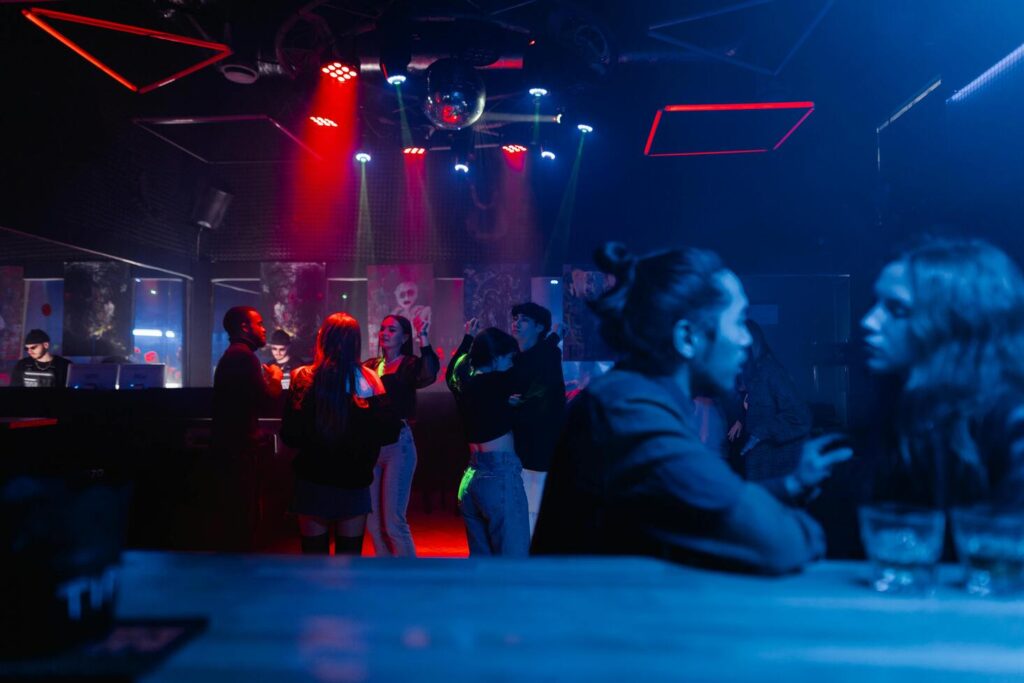 Nightclub with red and blue lighting where people socialize at Nashville's oldest restaurant establishment