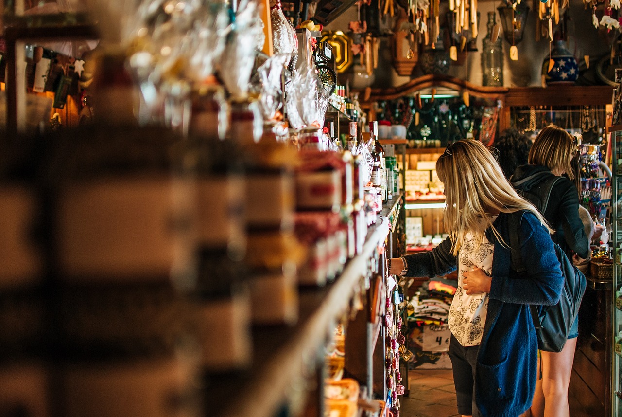Two girls happily browsing and shopping for vintage treasures in a charming Nashville neighborhood antique store