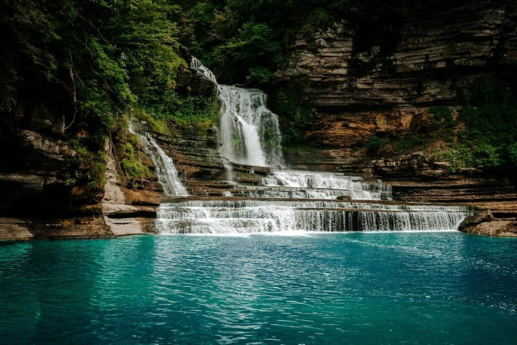 Stunning Hidden Nashville waterfall cascades over limestone in to turquoise waters, a natural Music City gem
