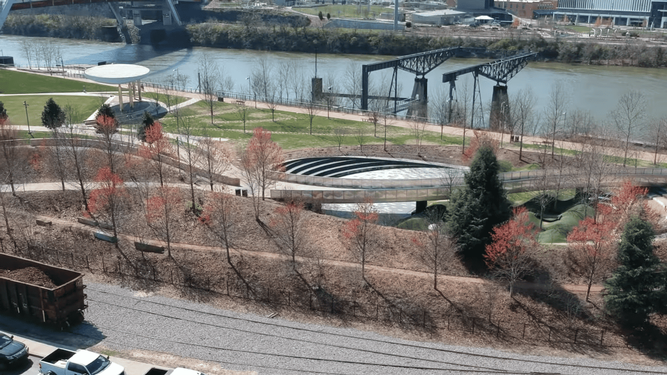 Cumberland River park includes walking paths, an amphitheater, and the Nashville skyline visible in the distance