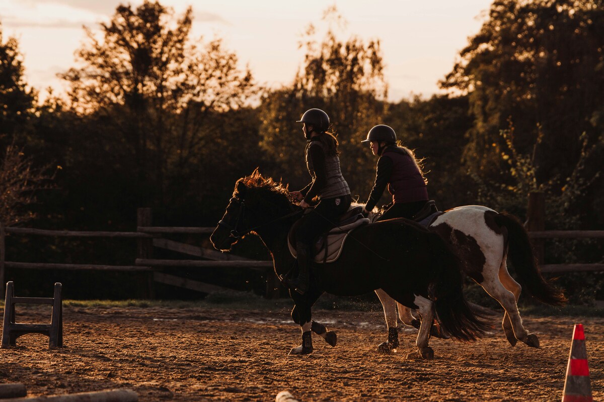 Horseback riders enjoying a sunset trail ride, representing Nashville's "Ride a Horse, Save a Cowboy" activity