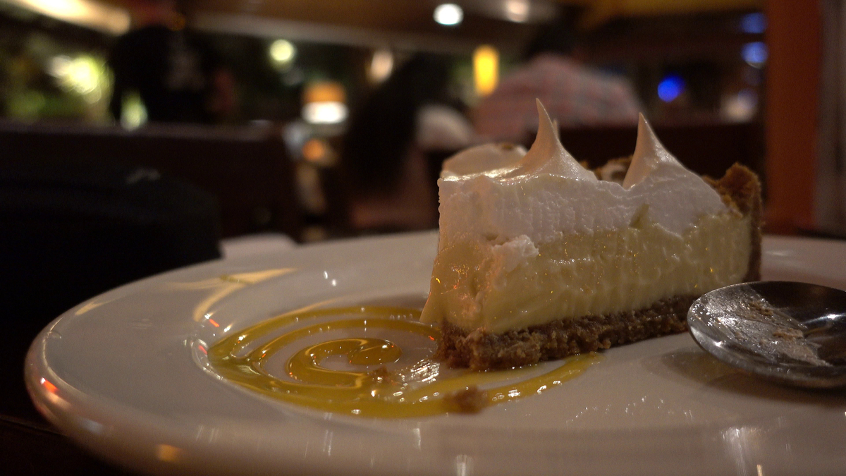 Elegant dessert with meringue peaks and golden sauce drizzle showcasing fine dining at best East Nashville restaurants