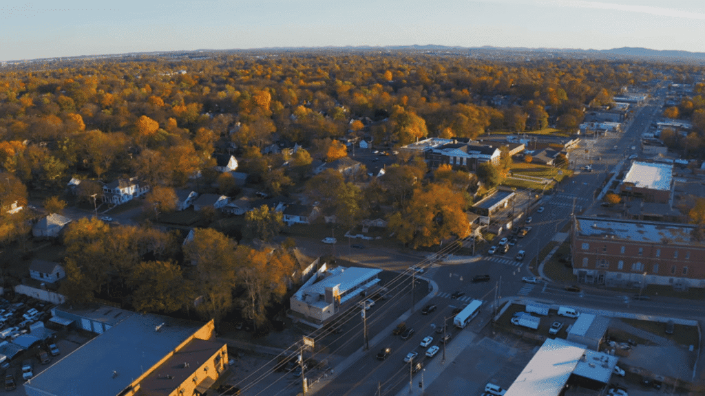East Nashville History: Contemporary drone shot of peaceful tree-lined neighborhood during golden autumn hour with sunlight