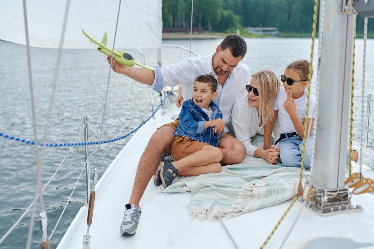 Family sailing on boat with children playing with toy airplane on Cumberland River near Nashville Tennessee
