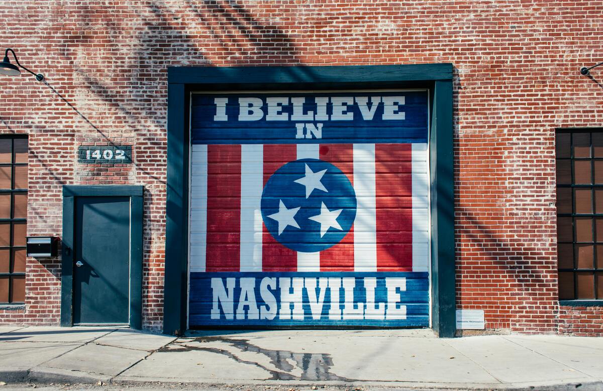 Vibrant 'I Believe in Nashville' mural on a painted brick wall in a trendy arts district