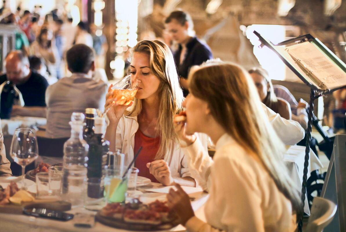 Friends happily enjoying drinks and lunch in a lively Nashville restaurant during their exciting one-day adventure