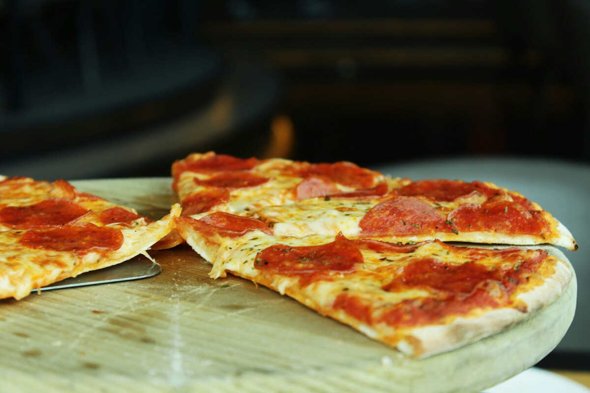 Classic pepperoni pizza slices with stretchy cheese highlighting Italian offerings at best East Nashville restaurants