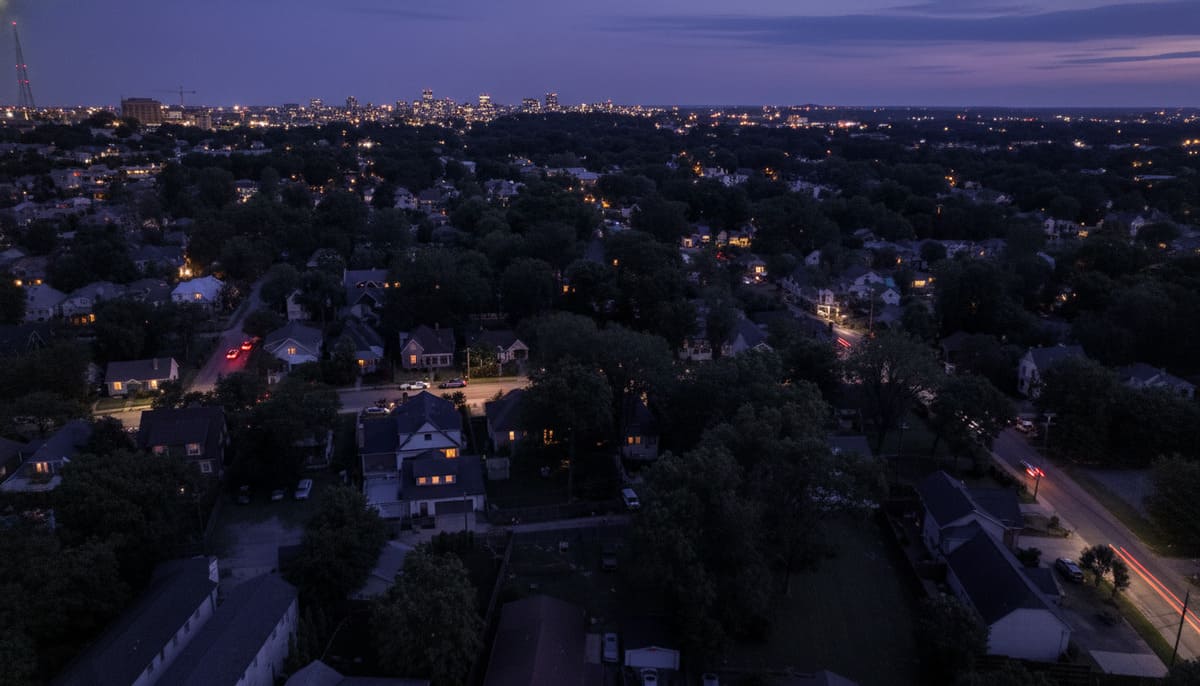 Bellevue residential streets at dusk with glowing lights and Nashville downtown skyline in peaceful Nashville suburbs for families