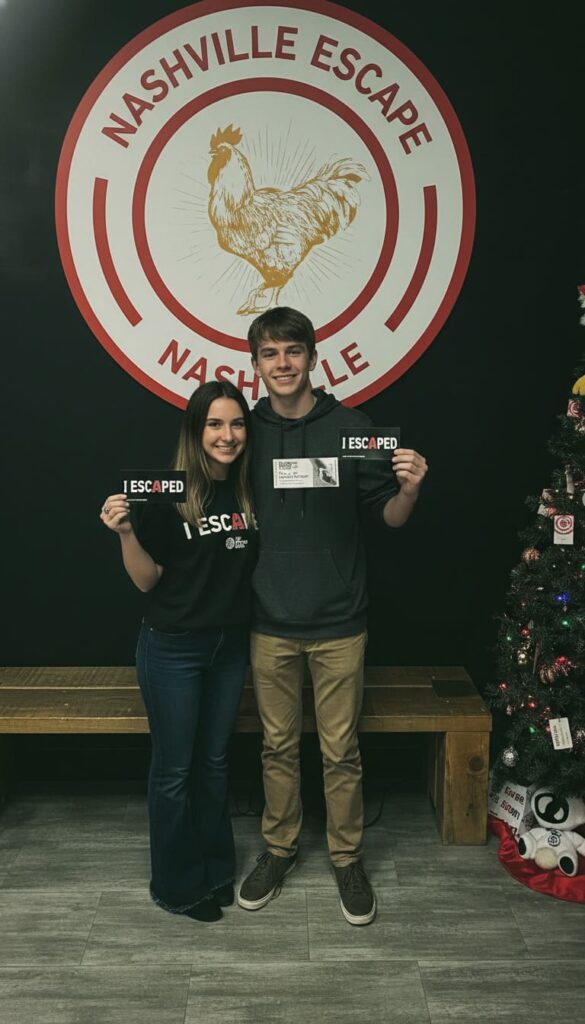 Excited teenage couple holding completion certificates after executing Nashville escape room date night ideas for adventurous couples