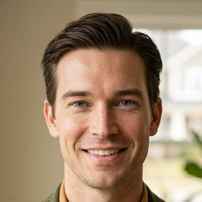Ronan Hale in olive blazer smiling warmly inside a Nashville home with natural window light
