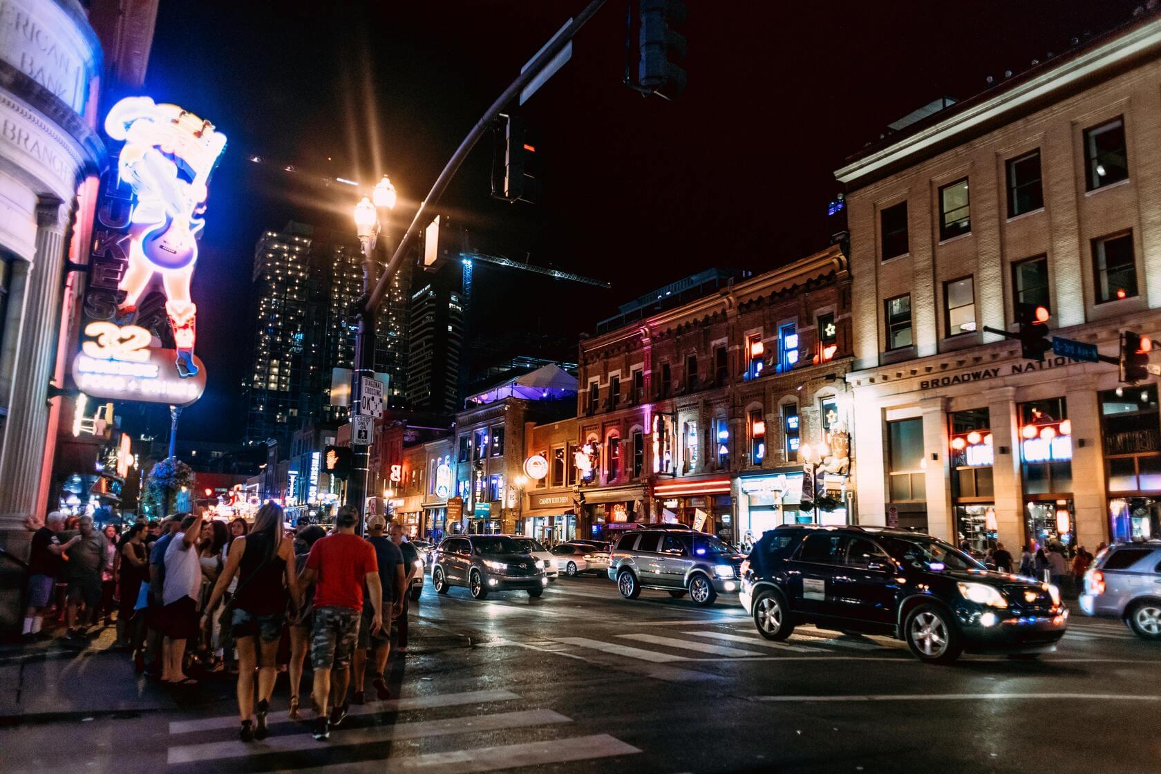 Tourists excitedly exploring Broadway nightlife with entertainment budget plans, tips, and affordable bars in downtown Nashville